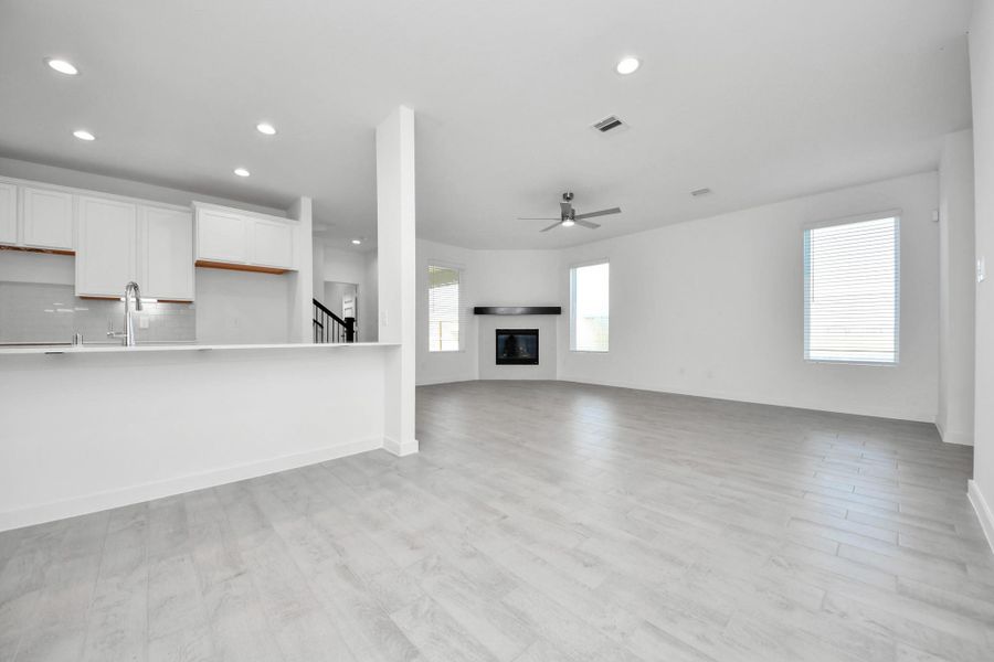 Make memories gathered around the table with your family and friends! This spacious dining room features elegant flooring, custom paint, and adjacent to family room and kitchen for open concept feel. Sample photo of completed home with similar floor plan. Actual colors and selections may vary.