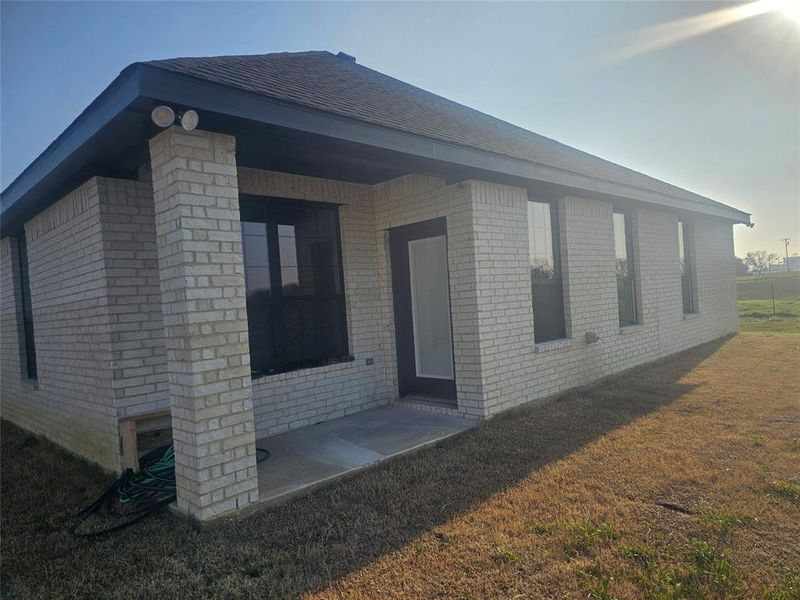 View of side of home featuring a lawn