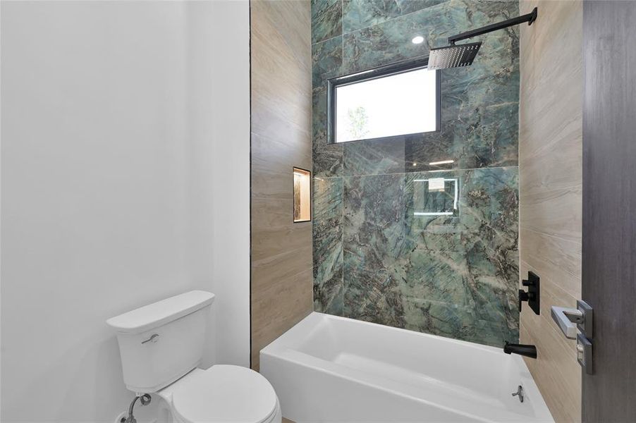 Luxurious shower/tub combo featuring elegant Spanish porcelain tile.