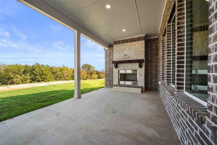 View of patio / terrace with an outdoor stone fireplace View of patio / terrace with an outdoor stone fireplace