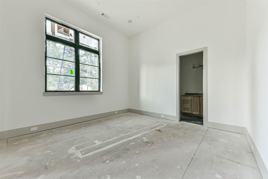 The first floor study features large picture windows, 14 foot tall ceilings and an ensuite bath with walk-in closet so it could be used as a 5th bedroom. This progress photo was taken May 26th.