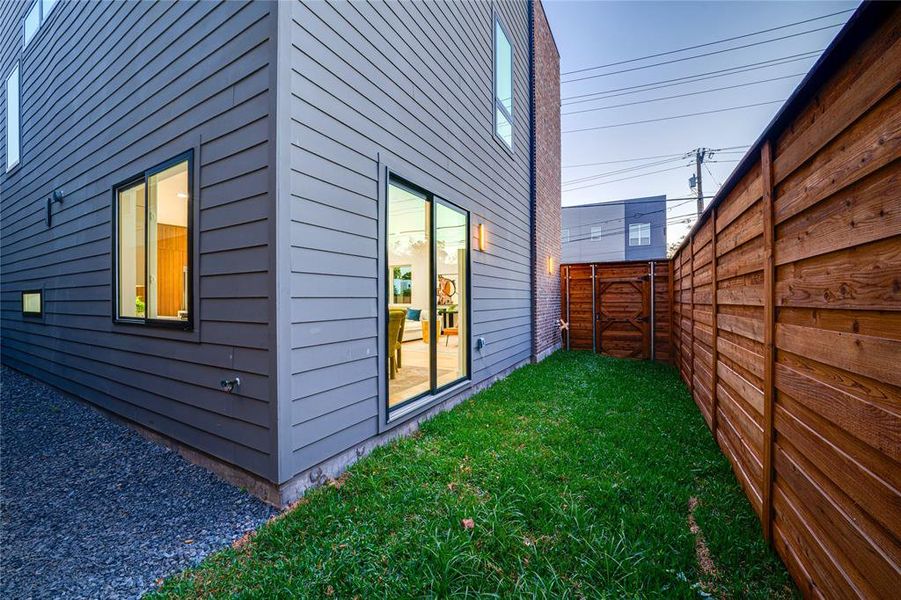 View of side of property featuring a yard