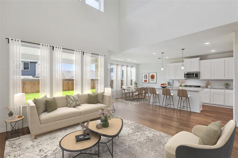 Living room featuring a towering ceiling, dark hardwood / wood-style floors, and sink