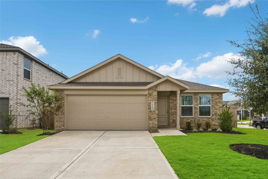 Charming single-story home with a modern brick façade, featuring a spacious two-car garage and well-maintained landscaping on a quiet suburban street.