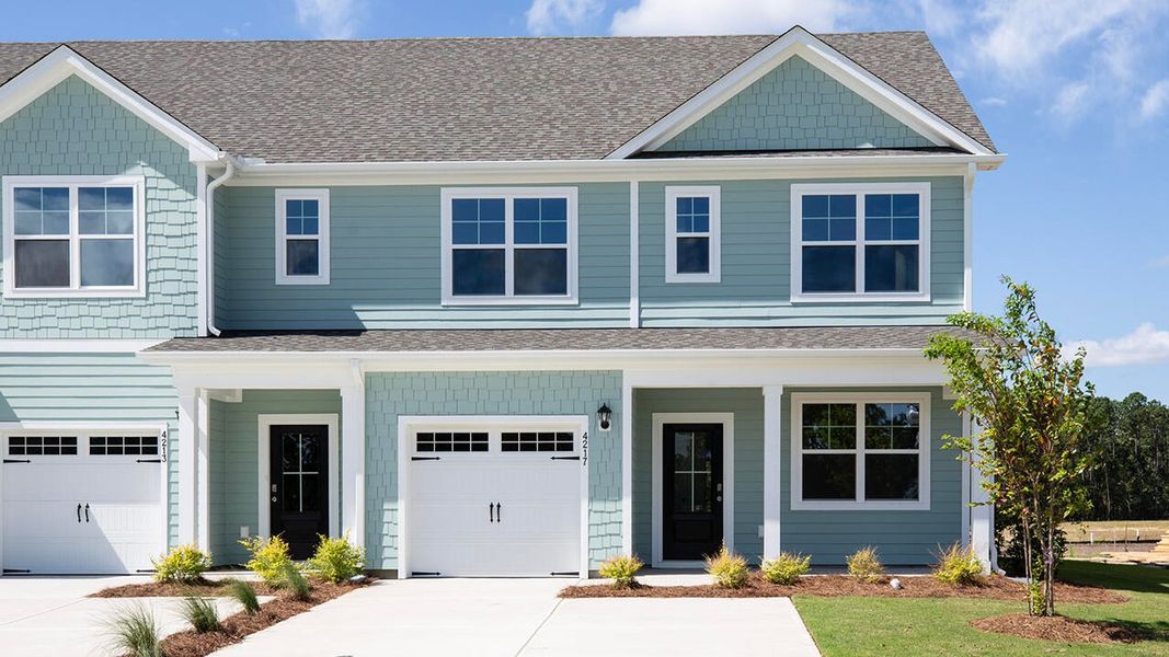 Front exterior of a new home in Indigo Preserve Townhomes, Leland, NC, highlighting curb appeal (Image 1). Front exterior of a new home in Indigo Preserve Townhomes, Leland, NC, highlighting curb appeal (Image 1).