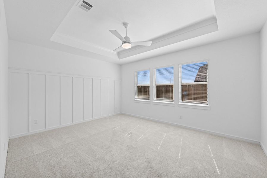 Spacious primary suite with a feature wall