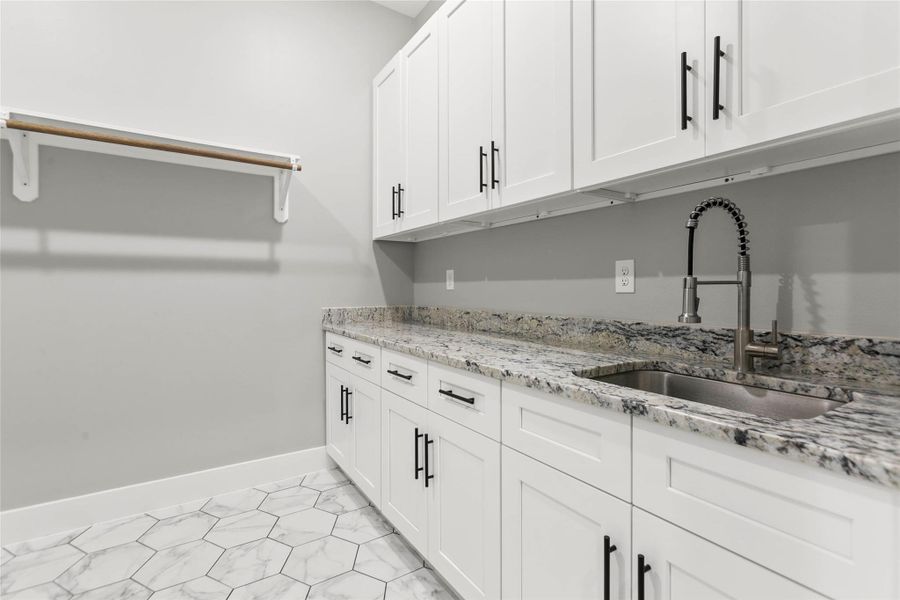 The expansive laundry room with sink and plenty of storage. The expansive laundry room with sink and plenty of storage.