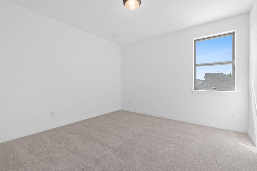 Empty room with light carpet and baseboards
