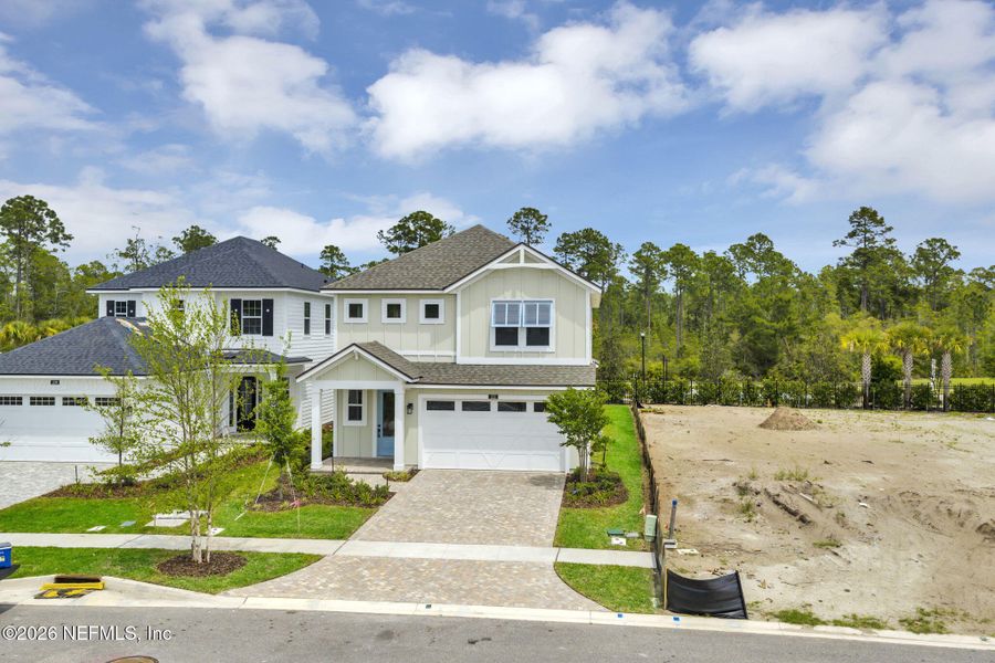 Front exterior of a new home in Seabrook Village at Seabrook, Ponte Vedra, FL, highlighting curb appeal (Image 23). Front exterior of a new home in Seabrook Village at Seabrook, Ponte Vedra, FL, highlighting curb appeal (Image 23).