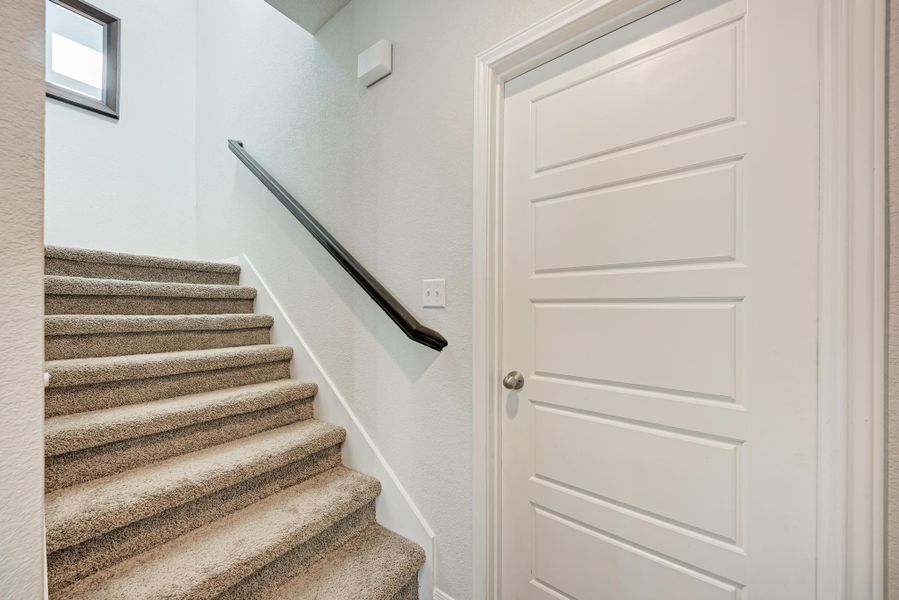 Stairway featuring a textured wall