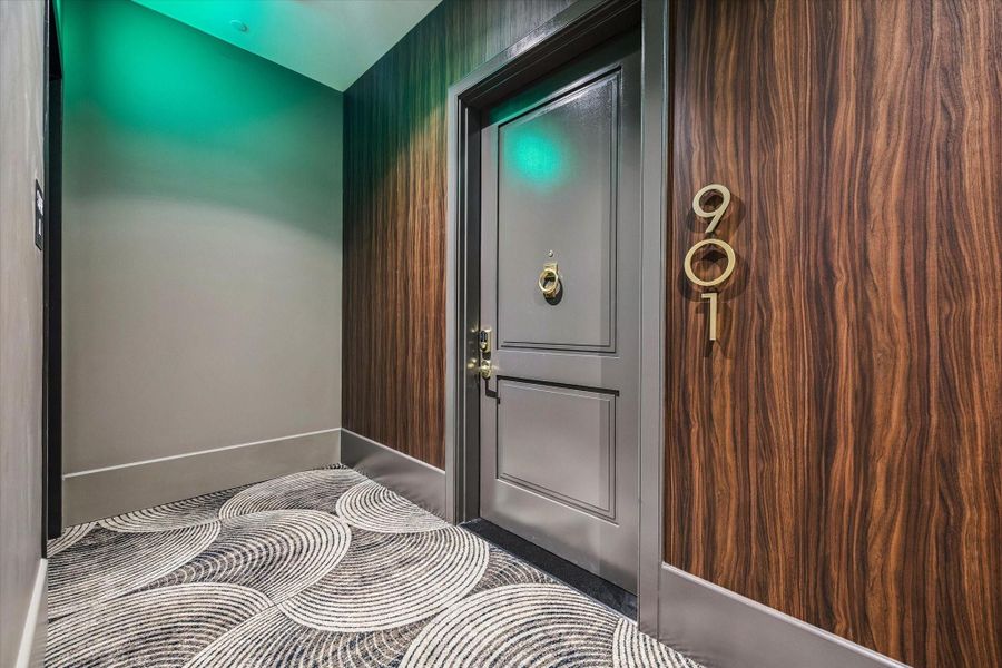 A private entry welcomes you to Residence #901, featuring a refined corridor with designer finishes that set the tone for the sophisticated living experience within.
