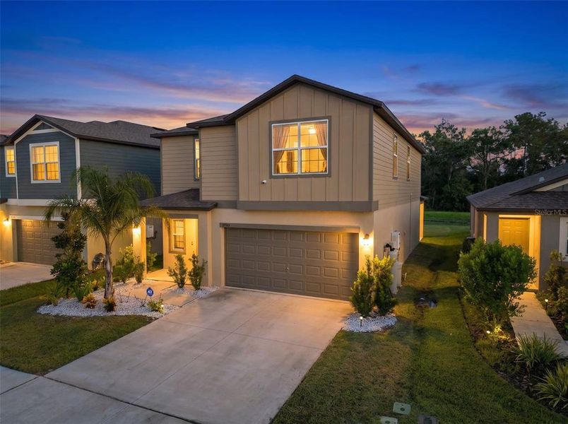 Front exterior of a new home in Two Rivers, Zephyrhills, FL, highlighting curb appeal (Image 2). Front exterior of a new home in Two Rivers, Zephyrhills, FL, highlighting curb appeal (Image 2).