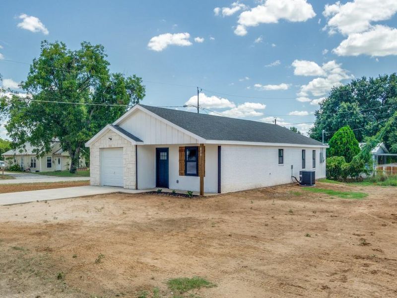 Ranch-style house featuring central AC unit and a garage Ranch-style house featuring central AC unit and a garage