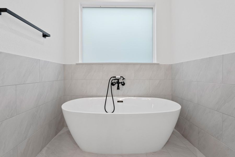 Indulge in relaxation with this charming soaking tub, perfect for unwinding. Indulge in relaxation with this charming soaking tub, perfect for unwinding.