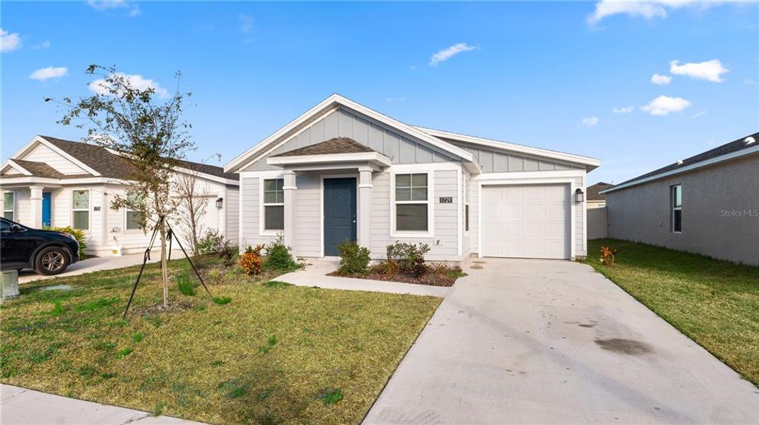 Front exterior of a new home in Peace Creek Reserve: Legacy Collection, Winter Haven, FL, highlighting curb appeal (Image 26).