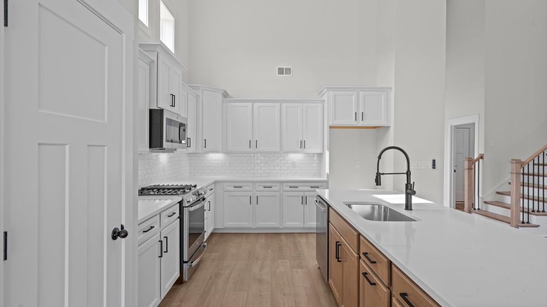 Elegant and compact island anchors this tasteful kitchen with high standards and timeless appeal