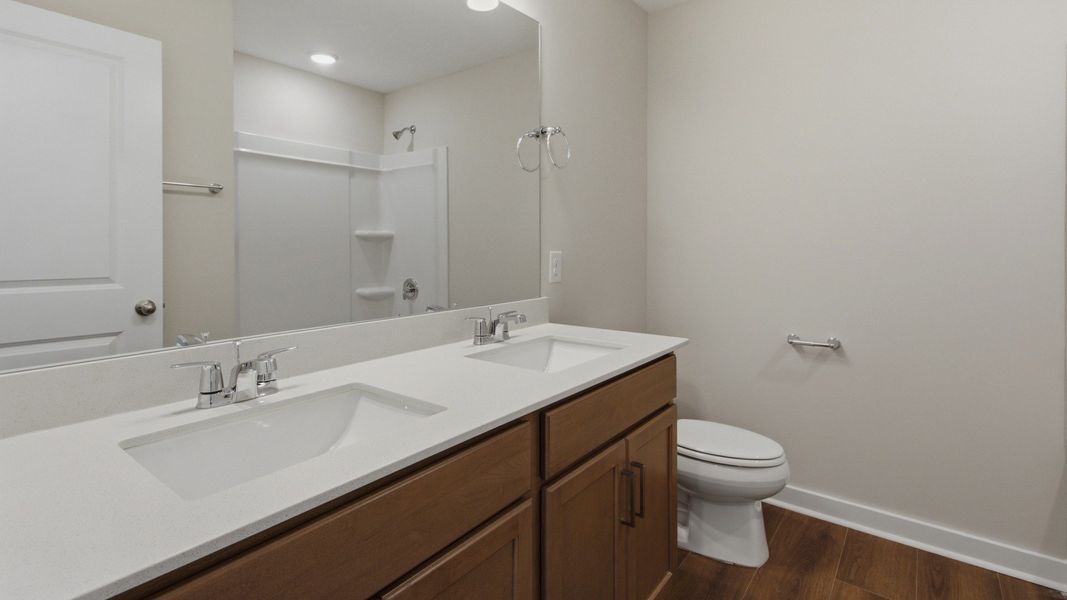 Secondary bathroom with large mirror and dual sinks Secondary bathroom with large mirror and dual sinks