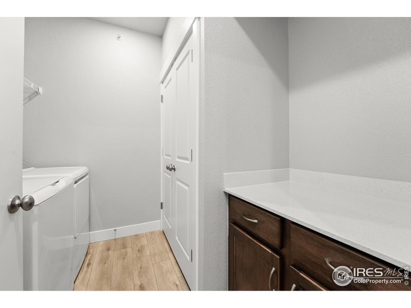 Laundry room w/ built in cabients & shelving. Washer and dryer included