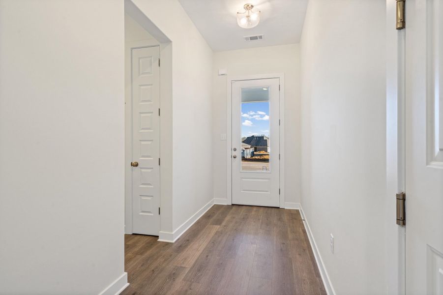 Corridor with baseboards and dark wood-style flooring
