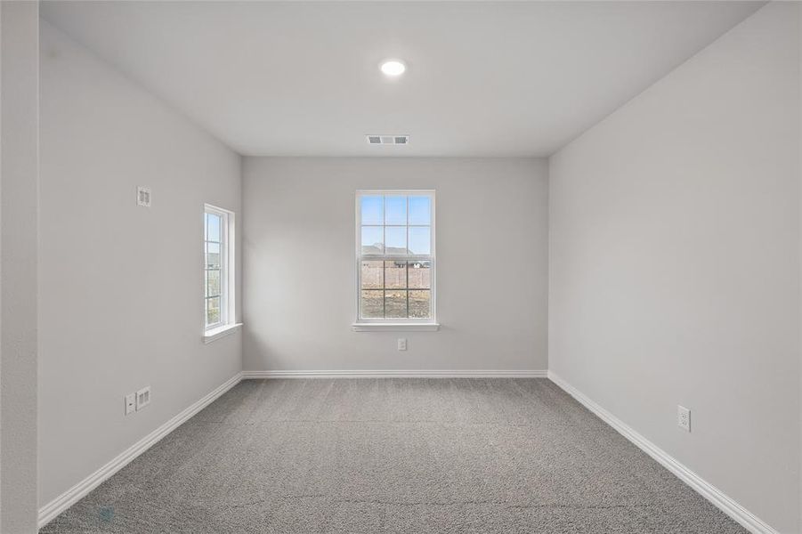 Carpeted spare room with healthy amount of natural light and recessed lighting