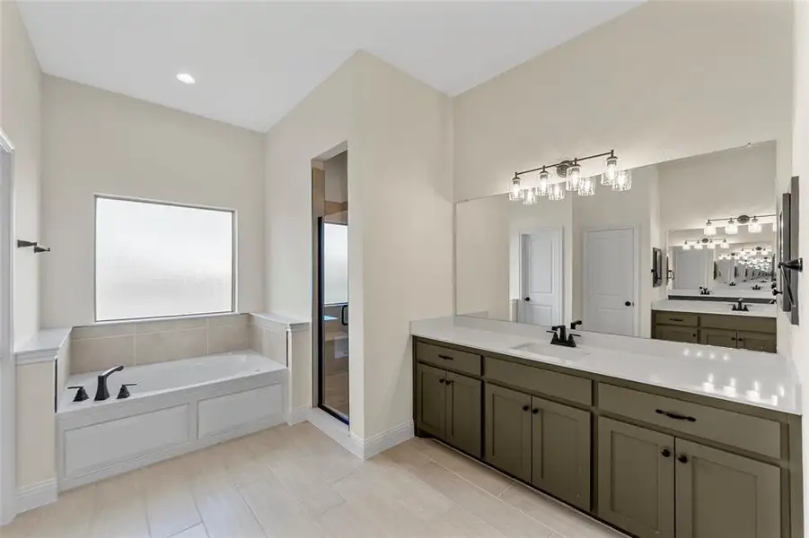 Full bath with vanity, a bath, and a shower stall Full bath with vanity, a bath, and a shower stall