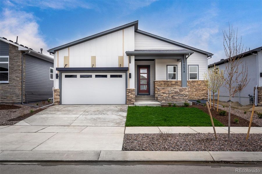 Front exterior of a new home in Wolf Ranch - Enclave Collection, Colorado Springs, CO, highlighting curb appeal (Image 1).