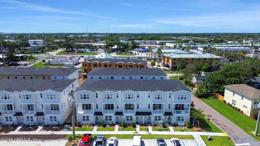 Front exterior of a new home in North Beach Townhomes, Jacksonville Beach, FL, highlighting curb appeal (Image 1).