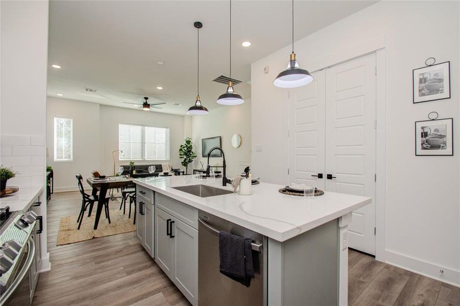 This attractive Kitchen is full of beautiful details. Quartz Countertops, Stainless Sink, Stainless Steel Appliances, Recessed Lighting and pendant lights, Undercabinet Lighting, Elegant Cabinetry with Soft Close Drawers and Doors. UNDER CONSTRUCTION!!  Photos from another community's model home FINISHES & COLORS MAY VARY! Ceiling fans are not included!