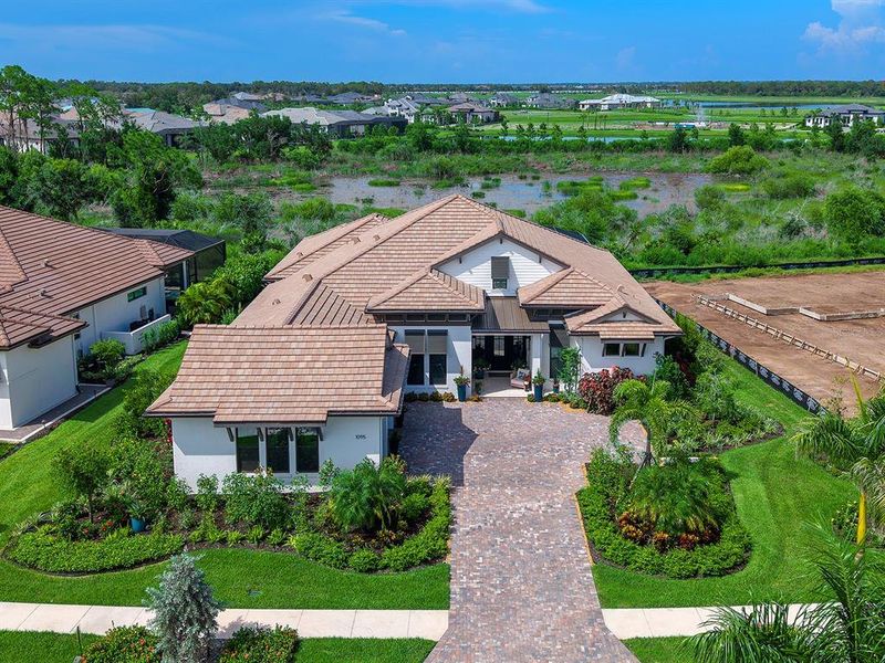 Front exterior of a new home in Wild Blue at Waterside, Sarasota, FL, highlighting curb appeal (Image 23). Front exterior of a new home in Wild Blue at Waterside, Sarasota, FL, highlighting curb appeal (Image 23).