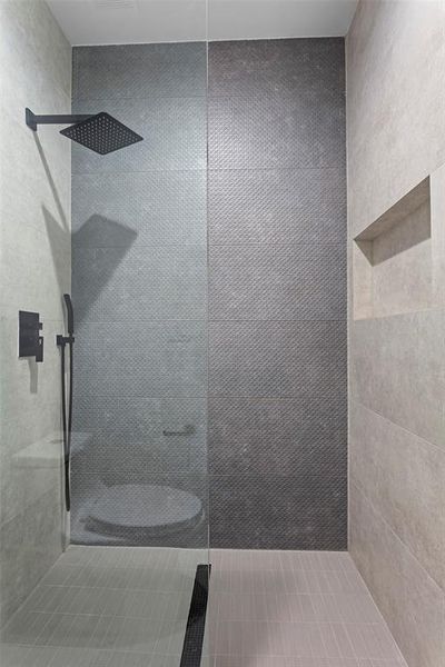 Bathroom featuring a tile shower