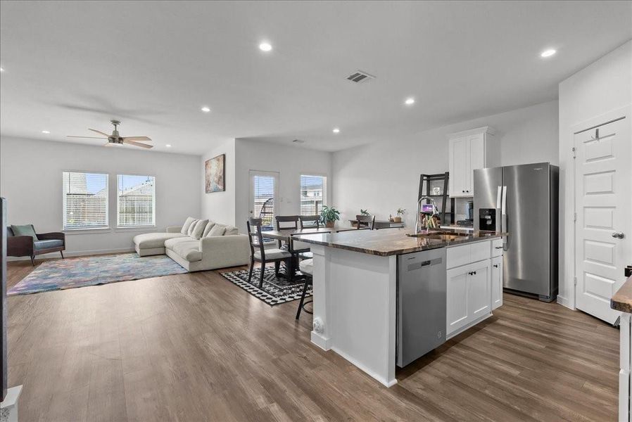 Open-concept design flows seamlessly into the spacious family room and dining area, making entertaining easy.