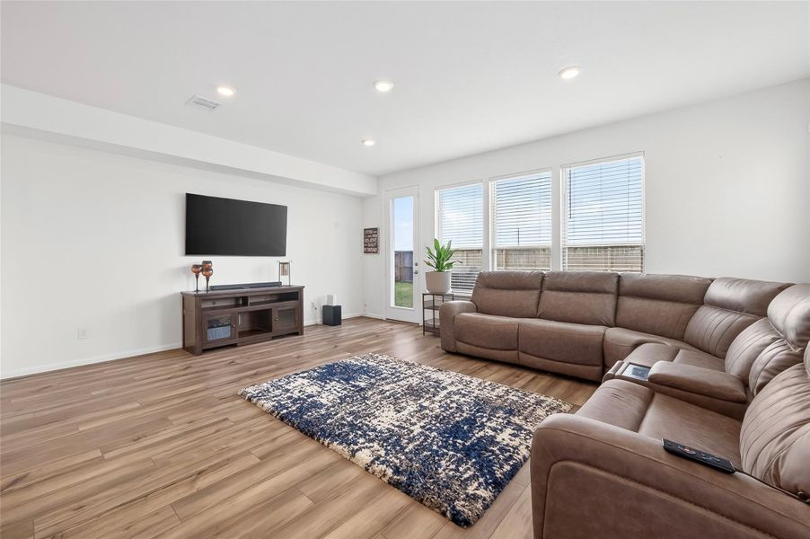 Bright living room filled with abundant natural light from large windows, creating a warm and inviting atmosphere