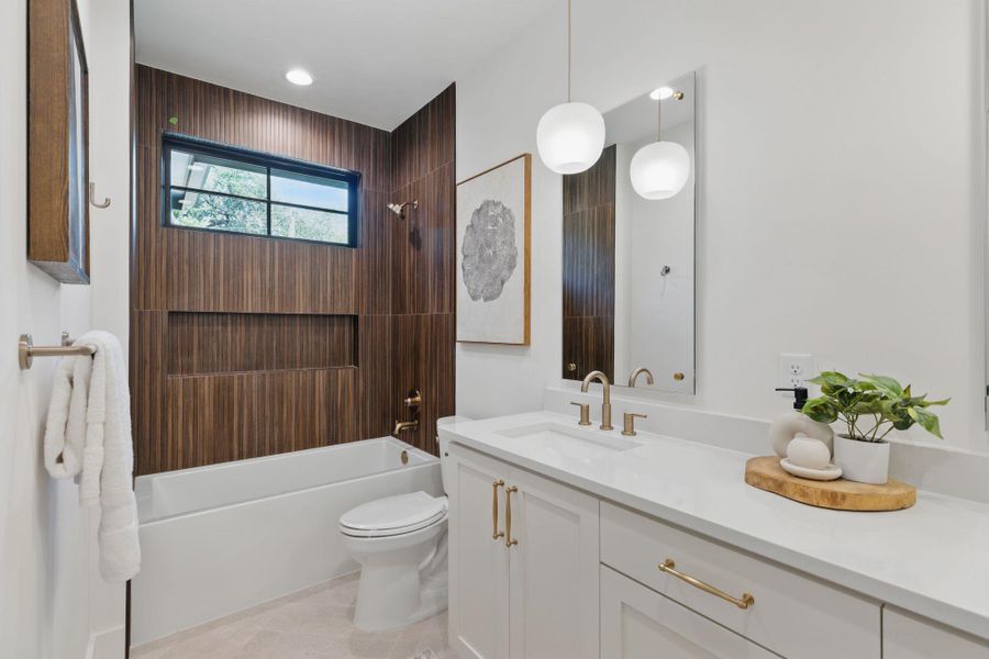 Bathroom with vanity, shower / tub combination, and tile patterned floors