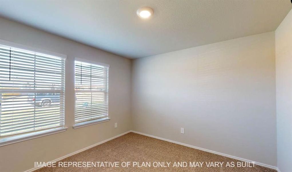 Bright room featuring two windows with horizontal blinds, neutral wall paint, and carpet flooring Bright room featuring two windows with horizontal blinds, neutral wall paint, and carpet flooring