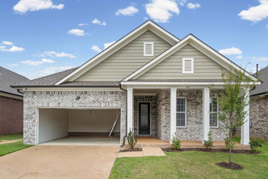 Brick and siding exterior featuring a covered front porch with white columns Brick and siding exterior featuring a covered front porch with white columns