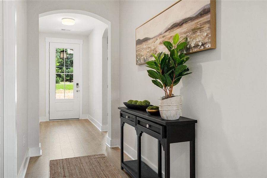 Enter into a bright hallway featuring light hardwo Enter into a bright hallway featuring light hardwo