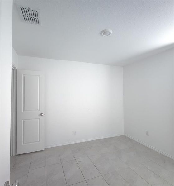 Empty room featuring light tile patterned flooring