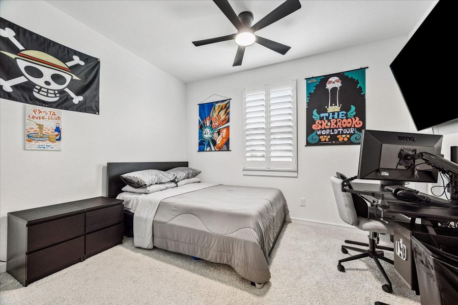 Bright secondary bedrooms feature neutral finishes, ceiling fans, and abundant natural light for comfortable everyday living.