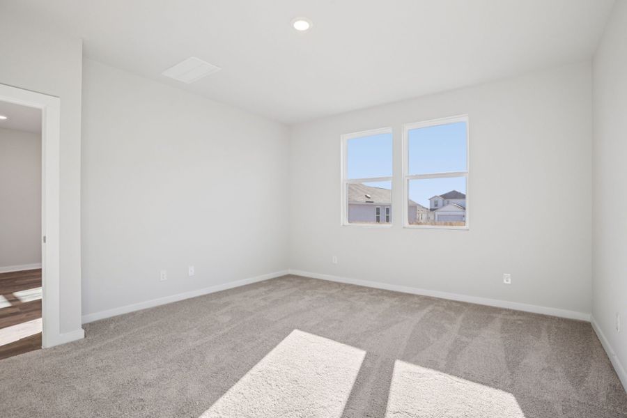 A room with a window and a rug.