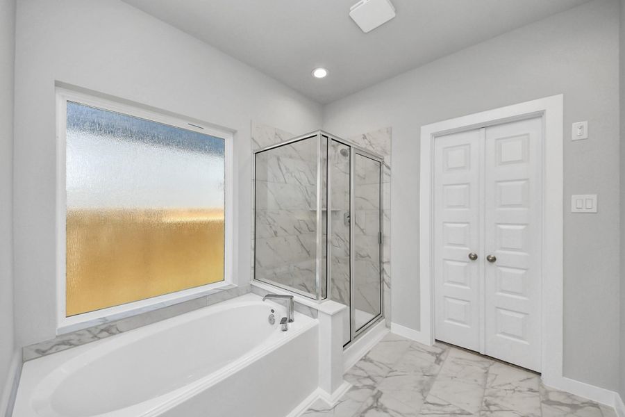 This additional view of the primary bath features a walk-in shower with the tile surround and separate garden tub perfect for soaking after a long day. Sample photo of completed home with similar floor plan. Actual colors and selections may vary. This additional view of the primary bath features a walk-in shower with the tile surround and separate garden tub perfect for soaking after a long day. Sample photo of completed home with similar floor plan. Actual colors and selections may vary.