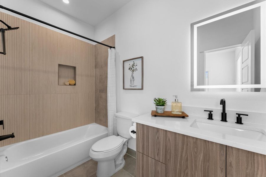 This ensuite bathroom, located in the third-floor secondary bedroom, showcases sleek modern finishes with stylish tile, a contemporary vanity topped with quartz countertops, and elegant lighting that brightens the space, creating a private retreat that is both functional and sophisticated. This ensuite bathroom, located in the third-floor secondary bedroom, showcases sleek modern finishes with stylish tile, a contemporary vanity topped with quartz countertops, and elegant lighting that brightens the space, creating a private retreat that is both functional and sophisticated.