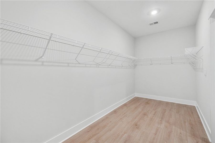 A generously sized walk-in closet with ample wire A generously sized walk-in closet with ample wire