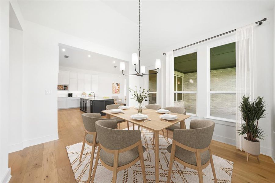Dining area featuring light wood-style flooring, a chandelier, and recessed lighting