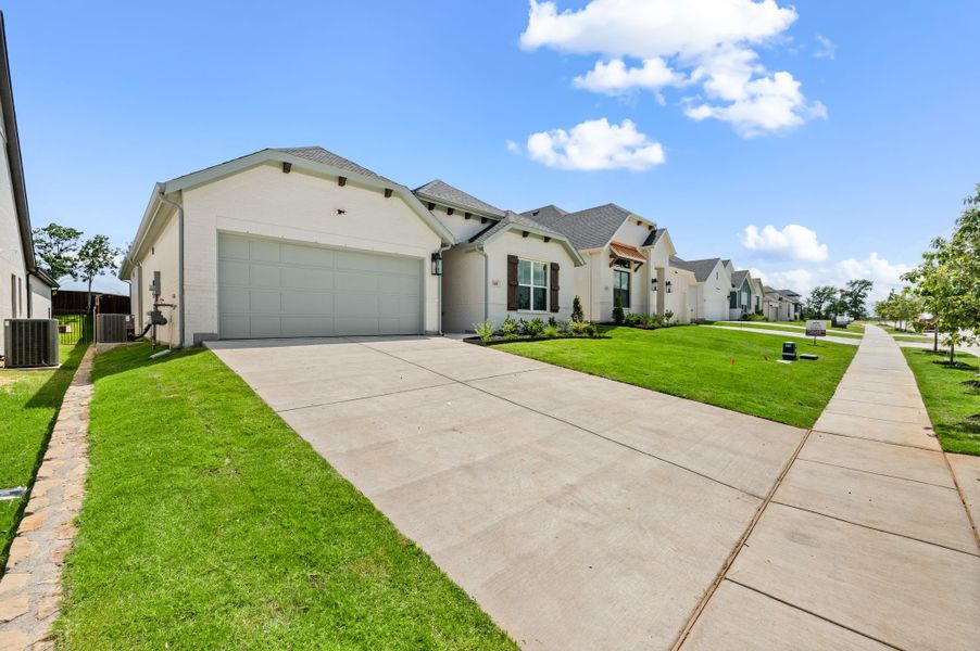 Front exterior of a new home in Parks of Aledo, Aledo, TX, highlighting curb appeal (Image 2). Front exterior of a new home in Parks of Aledo, Aledo, TX, highlighting curb appeal (Image 2).