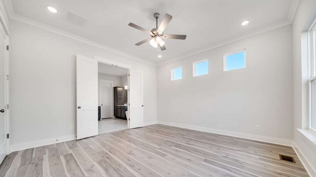Primary Bedroom with French doors leading to en-suite bathroom