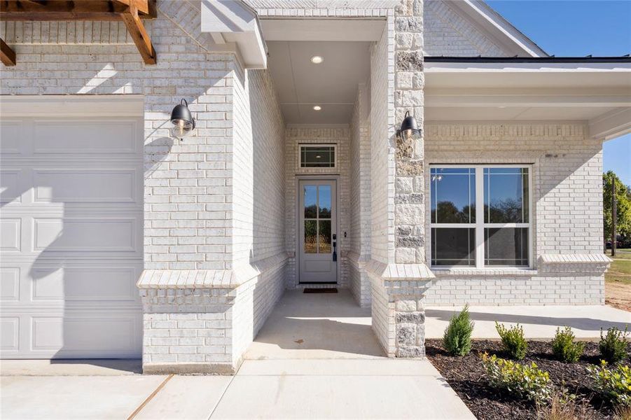 Doorway to property with a garage