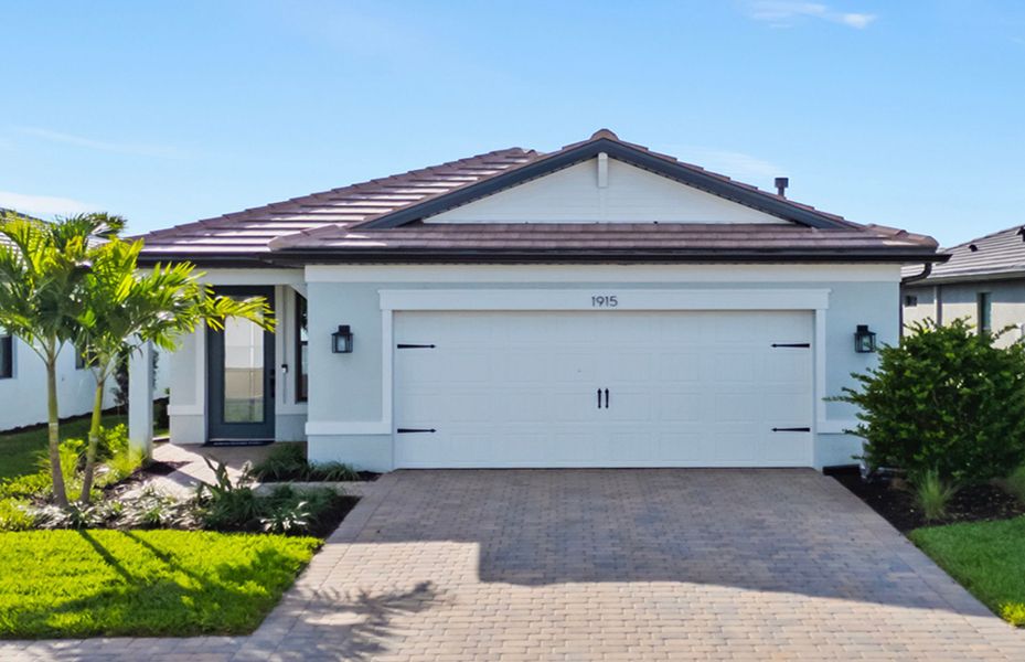 Front exterior of a new home in Terreno, Naples, FL, highlighting curb appeal (Image 1).