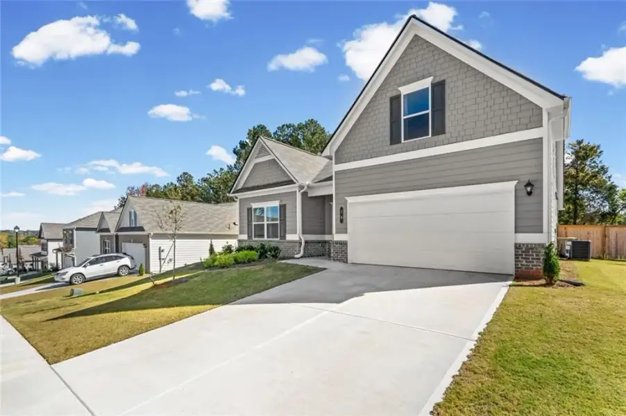 Front exterior of a new home in Allen Manor, Hoschton, GA, highlighting curb appeal (Image 1). Front exterior of a new home in Allen Manor, Hoschton, GA, highlighting curb appeal (Image 1).