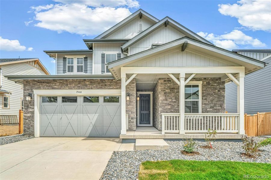 Front exterior of a new home in Windsong, Thornton, CO, highlighting curb appeal (Image 17).
