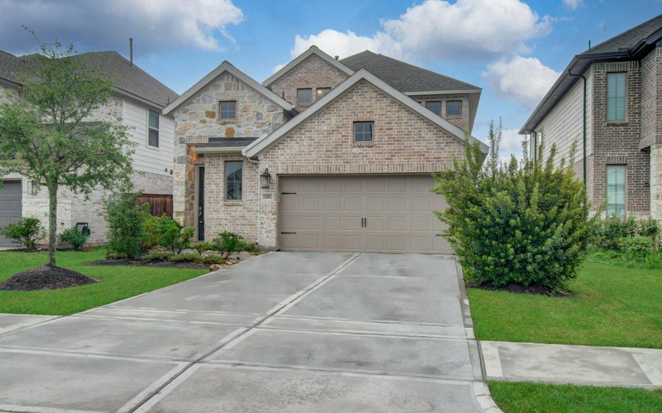 Front exterior of a new home in Candela, Richmond, TX, highlighting curb appeal (Image 1). Front exterior of a new home in Candela, Richmond, TX, highlighting curb appeal (Image 1).